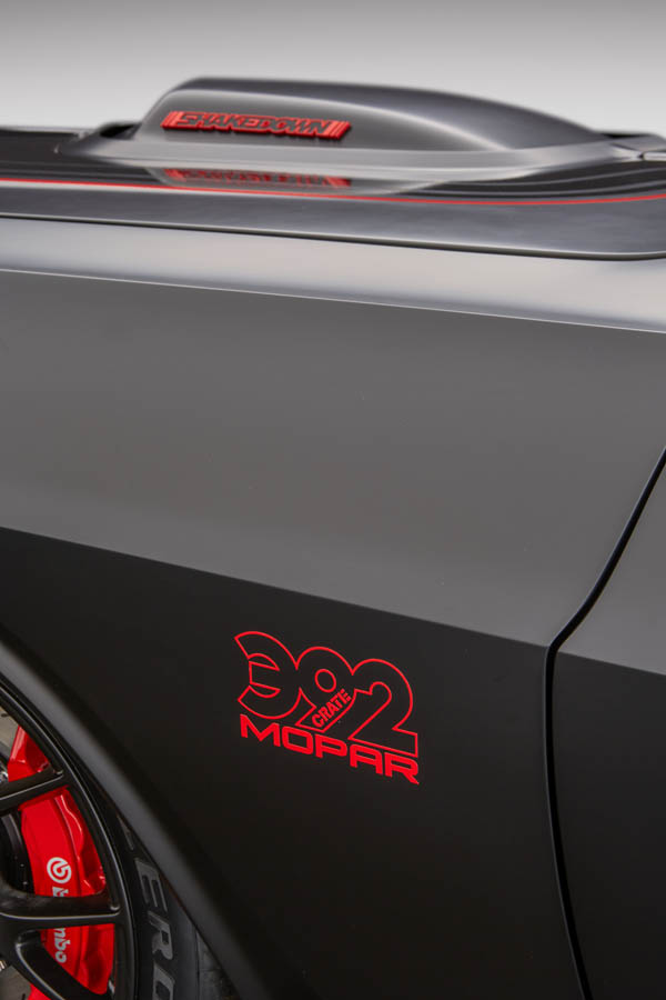 Matching red Mopar 392 logo decals on the front fenders complete